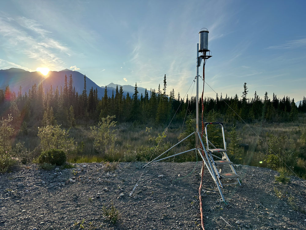 scientific apparatus with mountains in the background at sunset